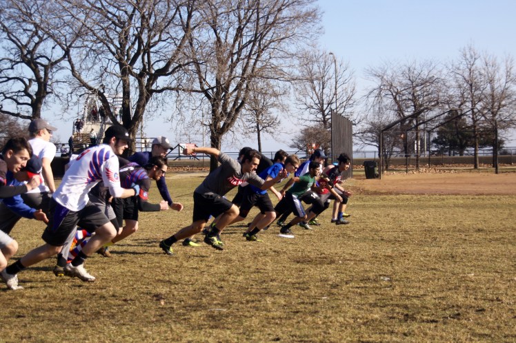 DePaul Ultimate Club members warm up by sprinting short distances during a sunny Saturday morning practice near Lake Michigan on Jan. 21, 2017. (Photo/Ben Rains)